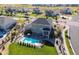 Aerial view of a backyard with a pool, patio with seating and a well-maintained lawn at 23230 E Rockinghorse Pkwy, Aurora, CO 80016