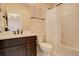 Well-lit bathroom featuring a dark vanity with a white countertop and a bathtub with white tiling at 23230 E Rockinghorse Pkwy, Aurora, CO 80016