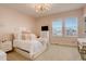 Cozy pink-themed bedroom with a large window, dresser, and soft carpet at 23230 E Rockinghorse Pkwy, Aurora, CO 80016