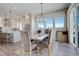 Inviting dining area with stylish chandelier, large windows, and an open view to the kitchen at 23230 E Rockinghorse Pkwy, Aurora, CO 80016