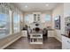 Bright home office featuring custom built-ins, spacious desk, and great natural light with neighborhood views at 23230 E Rockinghorse Pkwy, Aurora, CO 80016