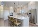 Bright kitchen featuring white cabinetry, stainless steel appliances, and a large island with seating at 23230 E Rockinghorse Pkwy, Aurora, CO 80016