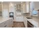 Elegant kitchen with white cabinets, a large island, stainless steel appliances, and modern fixtures at 23230 E Rockinghorse Pkwy, Aurora, CO 80016
