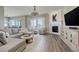 Comfortable living room featuring a fireplace, large windows, and modern furniture at 23230 E Rockinghorse Pkwy, Aurora, CO 80016