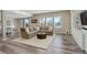 Bright living room with a large sectional sofa, big windows, and hardwood floors at 23230 E Rockinghorse Pkwy, Aurora, CO 80016