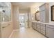 Luxurious main bathroom with dual vanities, a large glass shower, and an entrance to the main bedroom at 23230 E Rockinghorse Pkwy, Aurora, CO 80016