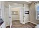 Open and airy office entryway through glass french doors featuring hardwood floors and neutral wall paint at 23230 E Rockinghorse Pkwy, Aurora, CO 80016