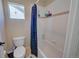 Bathtub and shower combination with blue shower curtain at 8641 Coors St, Arvada, CO 80005