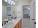 Bathroom featuring a double vanity and view into bedroom at 8641 Coors St, Arvada, CO 80005