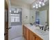 Bathroom boasts a double vanity and view to bedroom at 8641 Coors St, Arvada, CO 80005