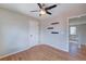 Simple bedroom with hardwood floors, a ceiling fan, and access to the upstairs hallway at 8641 Coors St, Arvada, CO 80005