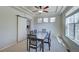 Bright dining room featuring a tray ceiling, modern lighting, and sliding barn door detail at 8641 Coors St, Arvada, CO 80005
