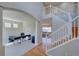 Spacious foyer featuring hardwood floors, a staircase, and an office area flooded with natural light at 8641 Coors St, Arvada, CO 80005
