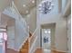 Open foyer featuring hardwood floors, a staircase, and a dining area with modern chandelier at 8641 Coors St, Arvada, CO 80005