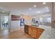 Open kitchen featuring wood cabinets, granite countertops, stainless steel appliances, and an adjacent living room at 8641 Coors St, Arvada, CO 80005