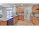 Bright kitchen with wood cabinets, granite countertops, stainless steel appliances, and hardwood floors at 8641 Coors St, Arvada, CO 80005