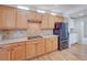 The kitchen boasts light wood cabinetry, granite countertops, and a sleek black refrigerator for a modern touch at 8641 Coors St, Arvada, CO 80005
