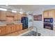 Spacious kitchen featuring wood cabinets, granite counters, stainless steel appliances, and a decorative coffee mug rack at 8641 Coors St, Arvada, CO 80005