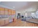 Stylish living area adjacent to the kitchen, showcasing hardwood floors, a fireplace, and ample natural light at 8641 Coors St, Arvada, CO 80005