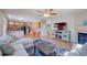 Open-concept living area showcasing hardwood floors, a unique entertainment center, and seamless flow into the kitchen at 8641 Coors St, Arvada, CO 80005