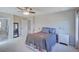 Spacious main bedroom with carpet, queen bed, ceiling fan, and easy access to the ensuite bath at 8641 Coors St, Arvada, CO 80005