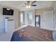 Carpeted main bedroom with a ceiling fan and TV; ensuite bath is conveniently through an arched doorway at 8641 Coors St, Arvada, CO 80005