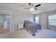 Cozy carpeted main bedroom with a ceiling fan, a comfy queen bed and natural light from dual windows at 8641 Coors St, Arvada, CO 80005