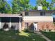 View of the home's back exterior with brick and siding, back door, and screened-in porch at 6649 Van Gordon Ct, Arvada, CO 80004