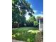 Lush backyard featuring mature trees and sprawling green lawn perfect for outdoor activities at 6649 Van Gordon Ct, Arvada, CO 80004