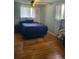 Cozy bedroom with hardwood floors, a ceiling fan, and a bright window letting in natural light at 6649 Van Gordon Ct, Arvada, CO 80004