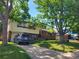 Charming two-story home with a well-manicured lawn and mature trees lining the property at 6649 Van Gordon Ct, Arvada, CO 80004