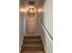 Hallway with carpeted stairs and a light fixture, leading to other areas of the home at 6649 Van Gordon Ct, Arvada, CO 80004