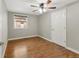 Cozy bedroom with laminate floors, ceiling fan, and a window allowing natural light at 457 Verdant Cir, Longmont, CO 80504