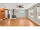 Bright living room featuring wood-look floors, a wood-burning stove, and multiple windows for natural light at 457 Verdant Cir, Longmont, CO 80504