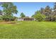 Lush backyard showcasing the home's serene outdoor space with mature trees and ample green space at 845 Everett St, Lakewood, CO 80215