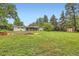Expansive backyard showcasing lush greenery and a charming patio, perfect for outdoor enjoyment and relaxation at 845 Everett St, Lakewood, CO 80215