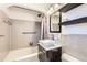 Bathroom featuring a sleek vanity with a stylish sink and shower/tub combination at 845 Everett St, Lakewood, CO 80215