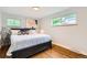 Comfortable bedroom with hardwood floors, bright windows, and a relaxing aesthetic at 845 Everett St, Lakewood, CO 80215