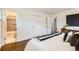 Comfortable bedroom offers hardwood floors and convenient access to the ensuite bathroom at 845 Everett St, Lakewood, CO 80215