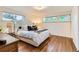 Cozy bedroom features hardwood floors, natural light, and neutral decor at 845 Everett St, Lakewood, CO 80215