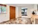 Welcoming entryway with tile flooring, a wooden door, and a glimpse into the home office at 845 Everett St, Lakewood, CO 80215