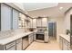 Bright kitchen featuring grey cabinets, stainless steel appliances, and a subway tile backsplash at 845 Everett St, Lakewood, CO 80215
