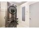 Modern laundry room featuring stacked washer and dryer units, and convenient utility storage at 845 Everett St, Lakewood, CO 80215