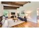 Cozy living room with hardwood floors, a decorative rug, a brick fireplace, and a modern entertainment center at 845 Everett St, Lakewood, CO 80215