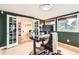Stylish home office with wood paneling, a modern desk, and views to the exterior at 845 Everett St, Lakewood, CO 80215