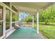 Covered patio with chairs, offering a peaceful outdoor seating area surrounded by lush greenery at 845 Everett St, Lakewood, CO 80215