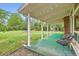 Inviting covered patio offering a serene view of the expansive backyard and lush greenery at 845 Everett St, Lakewood, CO 80215