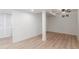 Finished basement area with plank flooring, a ceiling fan, and natural light from above-ground windows at 1570 S Chase St, Lakewood, CO 80232