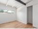 Bright room with light hardwood floors, black accent beam, and closet at 1570 S Chase St, Lakewood, CO 80232