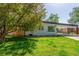 Charming home with lush front yard and covered parking offers great curb appeal at 1570 S Chase St, Lakewood, CO 80232